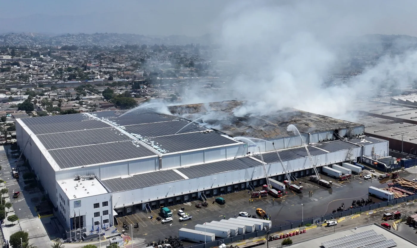 Smoke rising from a warehouse roof in Boyle Heights