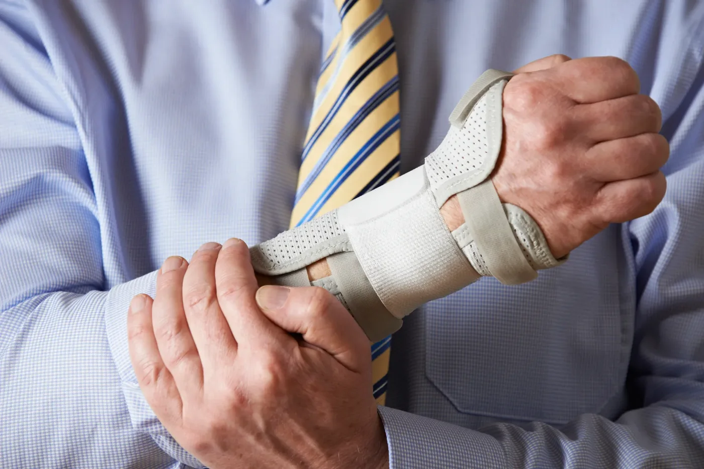 A person supporting an injured wrist in a brace