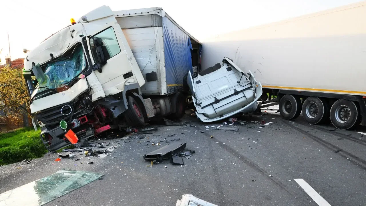 Two large trucks damaged in a collision